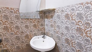 Un bagno con lavandino, specchio e piastrelle decorate.