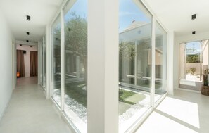 A modern interior with large glass doors leading to a garden area. - Stunning home in Pridraga (Pridraga)