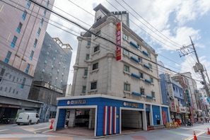 A hotel with a modern facade, multiple floors, and a prominent red sign. - Yeongdeungpo Hotel Jago (Seoul)