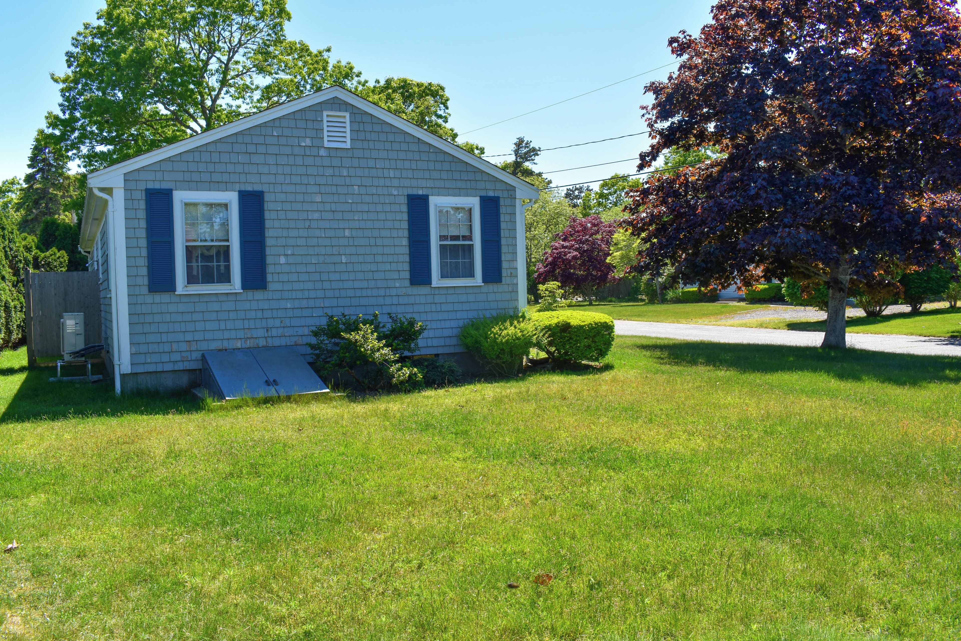 A single-story house with a front porch, a small attached garage, and a well-maintained lawn.