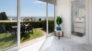 A modern room with a large sliding glass door leading to a balcony with a view of the sea. - AS MDS 172 in Mijas Costa (Mijas)
