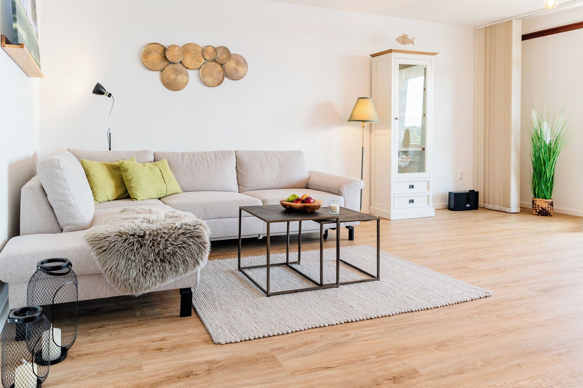A living room with a sofa, coffee table, and a decorative wall piece.