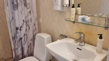 Shower, free toiletries, slippers, towels