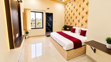A modern hotel room with a bed, bedside table, and a window with curtains.