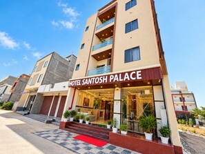 A hotel named 'Hotel Santosh Palace' with a modern facade, multiple balconies, and a red carpet entrance. - Santosh Palace  (Danta Ramgarh)