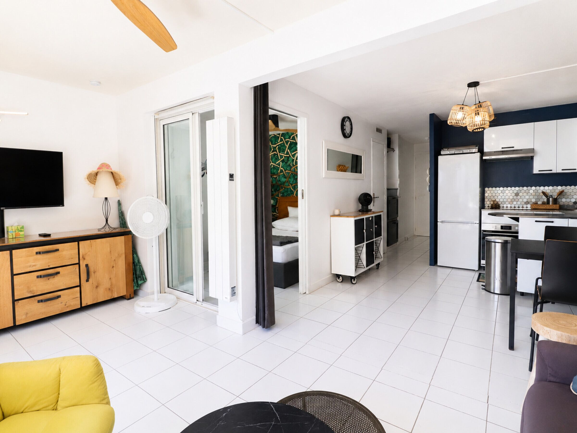 A modern apartment with a living room, kitchen, and dining area.