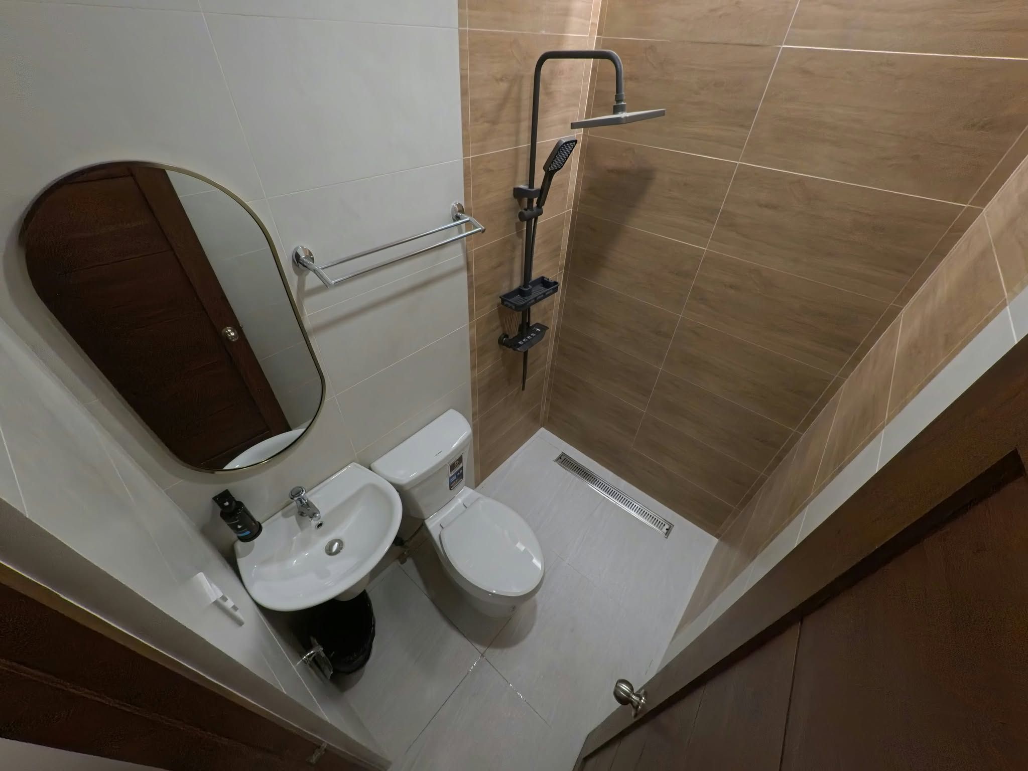 A bathroom with a toilet, sink, and shower.