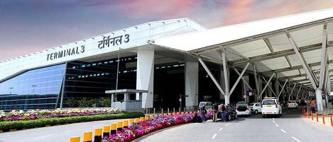 A modern airport terminal with a covered walkway, marked as Terminal 3.