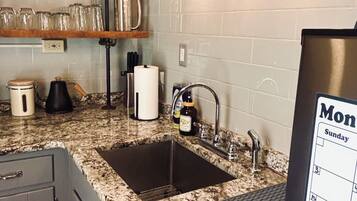 Fridge, microwave, coffee/tea maker, cookware/dishes/utensils