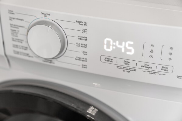 A washing machine control panel with a timer set to 0:45, various wash settings, and a digital display.