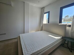 A bedroom with a bed, a window, and a view of the outdoors. - Larnaca s City Center Ermou Apartment (Larnaca)