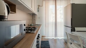 A compact kitchen with a stove, sink, and refrigerator. - A cozy 82 sqm apartment, ideal for 5 people, located on the first floor of a building with an elevator.The property is situated in Comasina, a residential area rich in amenities and green spaces, right next to Parco Nord Milano.The Comasina M3 metro stat (Milan)