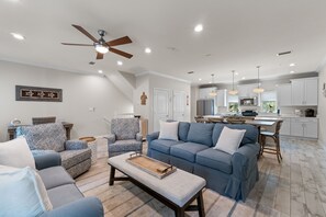 A modern living room with a sofa, armchair, and coffee table. - Welcome to the Turles Nest at Lost Key Golf & Beach Club (Perdido Key)