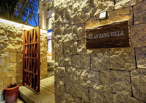 A stone wall with a wooden sign reading 'WAAN BANG VILLA.' - WA An Bang Villa Hoi An - Hidden Oasis (Hoi An)