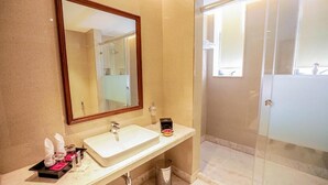 A bathroom with a sink, mirror, and shower area. - Gulab Kothi by Grapevine Varanasi (Varanasi)