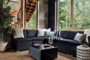 A modern living room with a sectional sofa, a coffee table, and a potted plant.