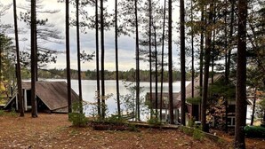 A forested area with a lake, a small cabin, and a tent. - Lost Lake Cottage

Munising/Wetmore (Munising Township)