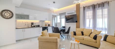 Una sala de estar moderna con un sofá, una mesa de centro y un televisor.