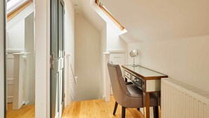 A modern room with a desk, chair, and radiator. - Host & Stay | The Spinney (Consett)