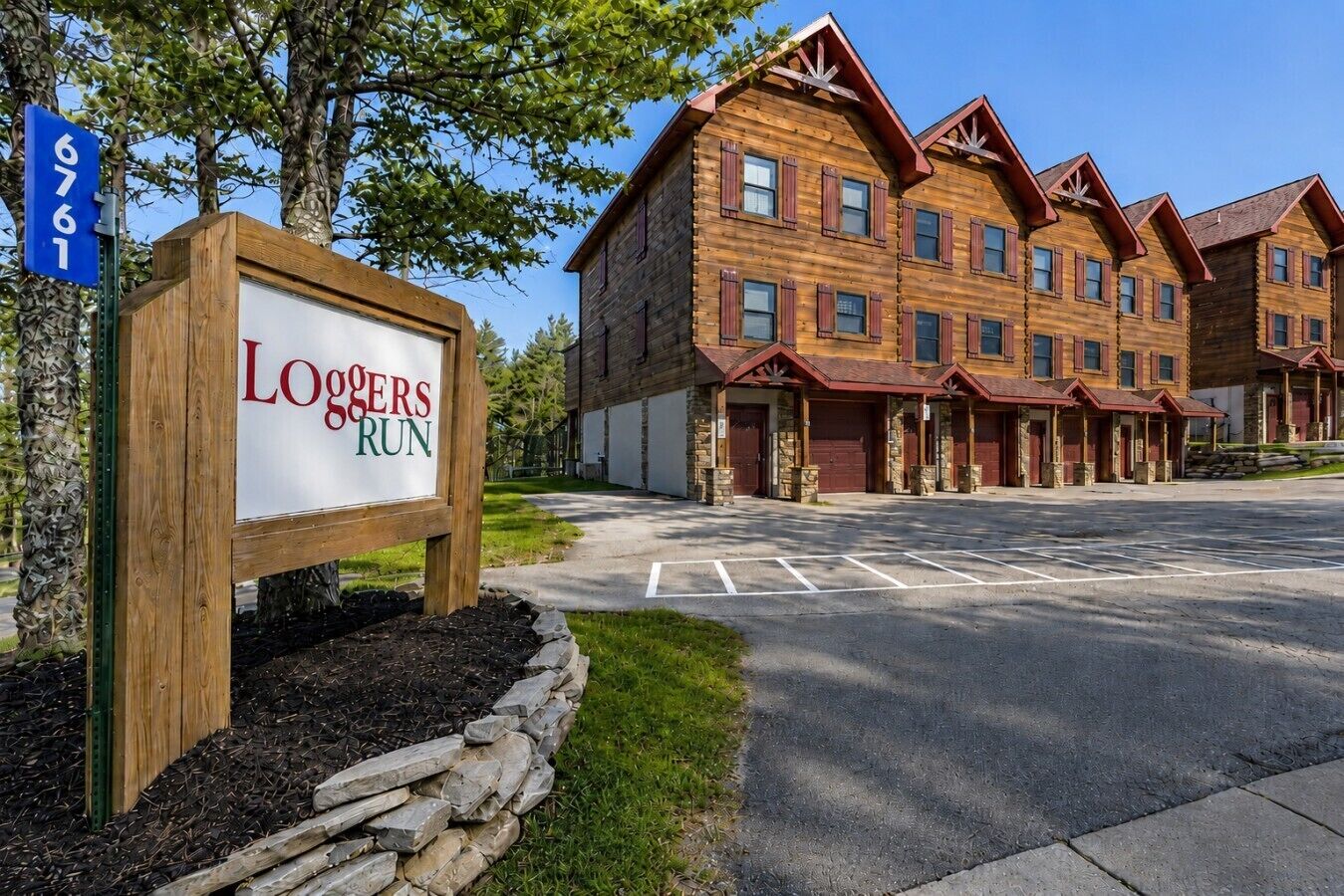 A wooden building with a sign reading 'Loggers Run' and a parking lot in front.