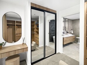 A modern bathroom with a large mirror, a wooden vanity, and a separate shower area. - Scenic Batemans Bay Stay Near Golf Course (Batemans Bay)