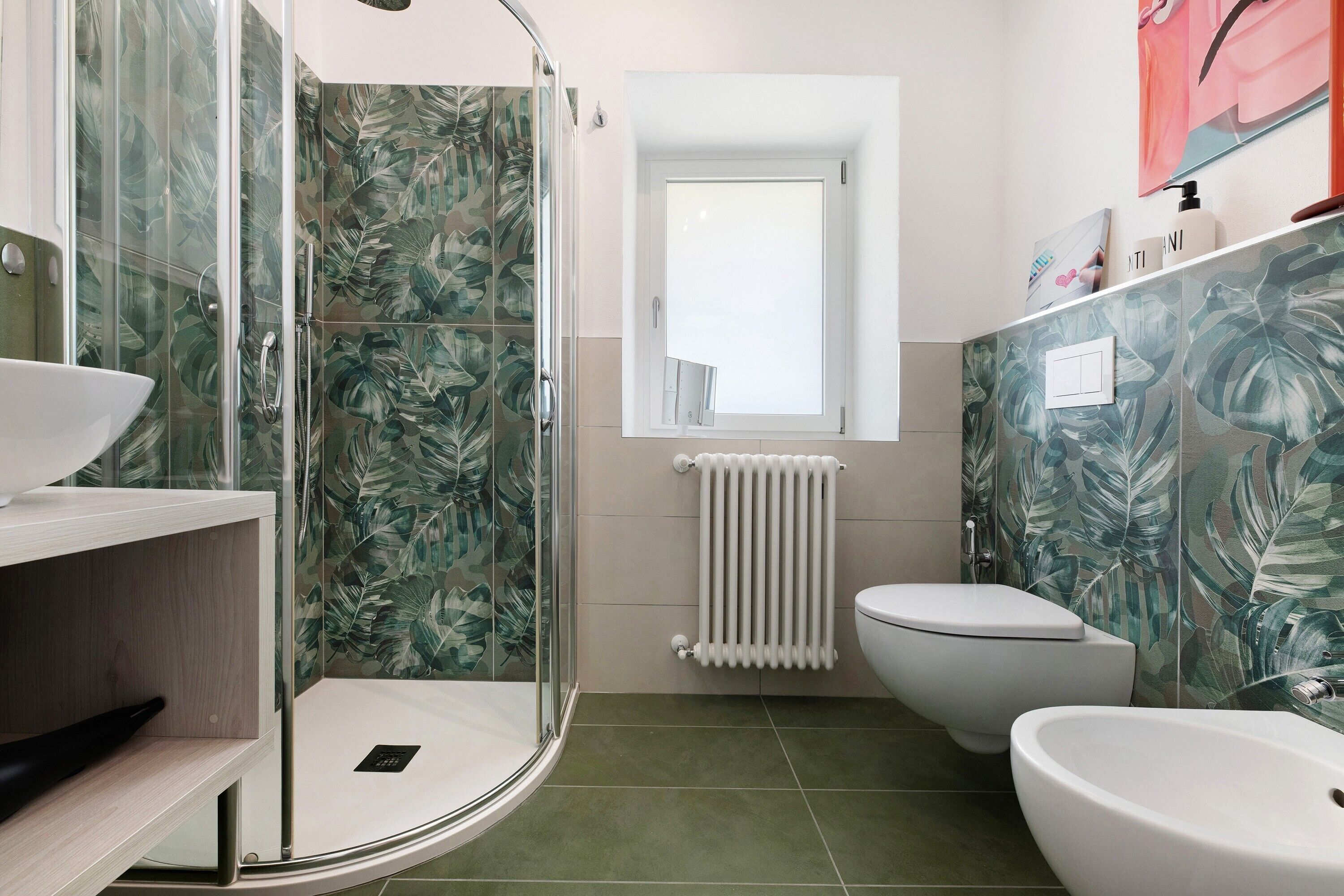 A bathroom with a shower, toilet, and sink.