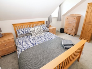 A bedroom with a bed, nightstands, a dresser, a wardrobe, and a window with curtains. - 8 Percy Terrace (Sunderland)