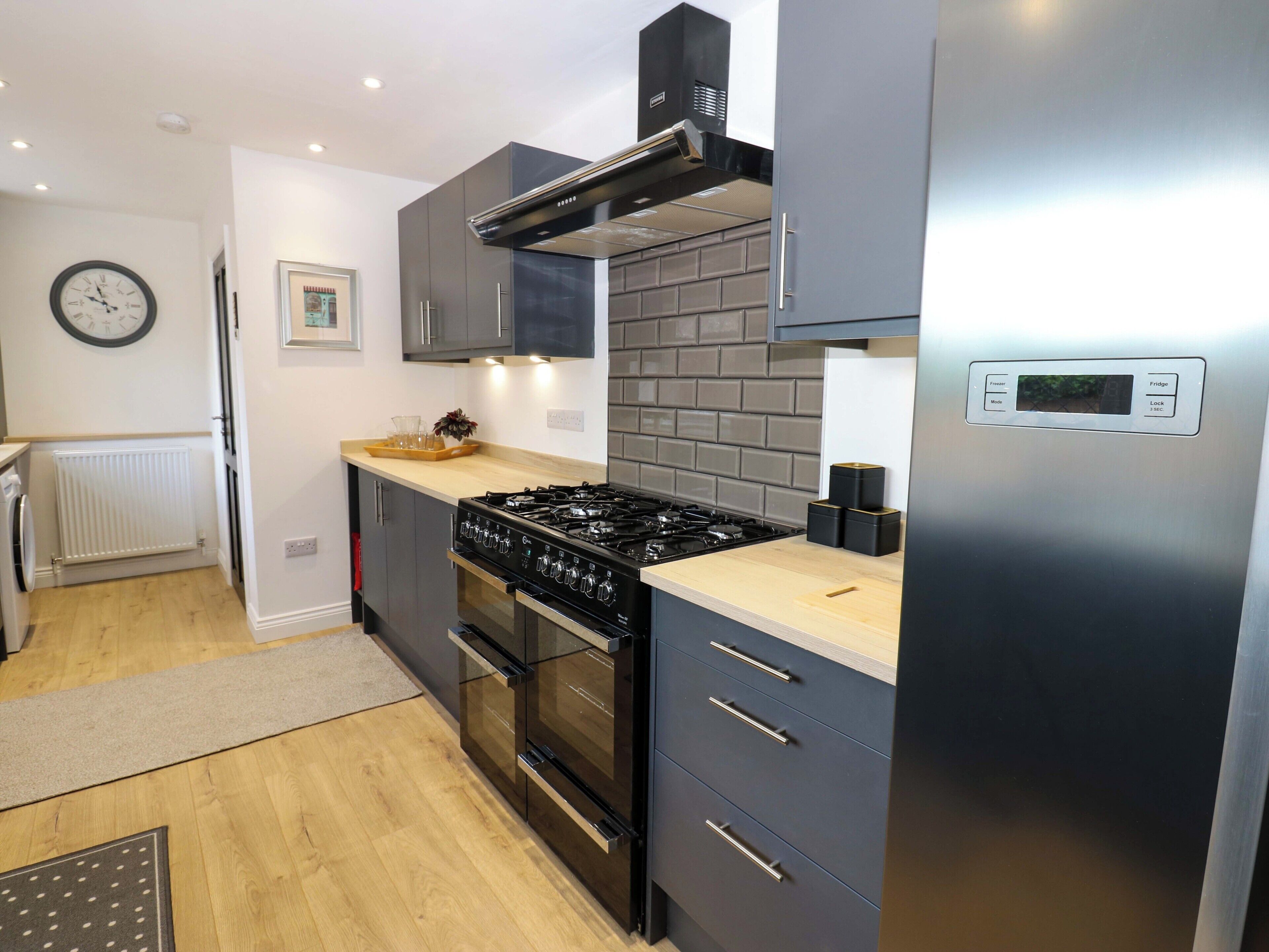 A modern kitchen with a gas stove, oven, and a built-in microwave.