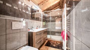 Un baño moderno con ducha, inodoro y lavabo.