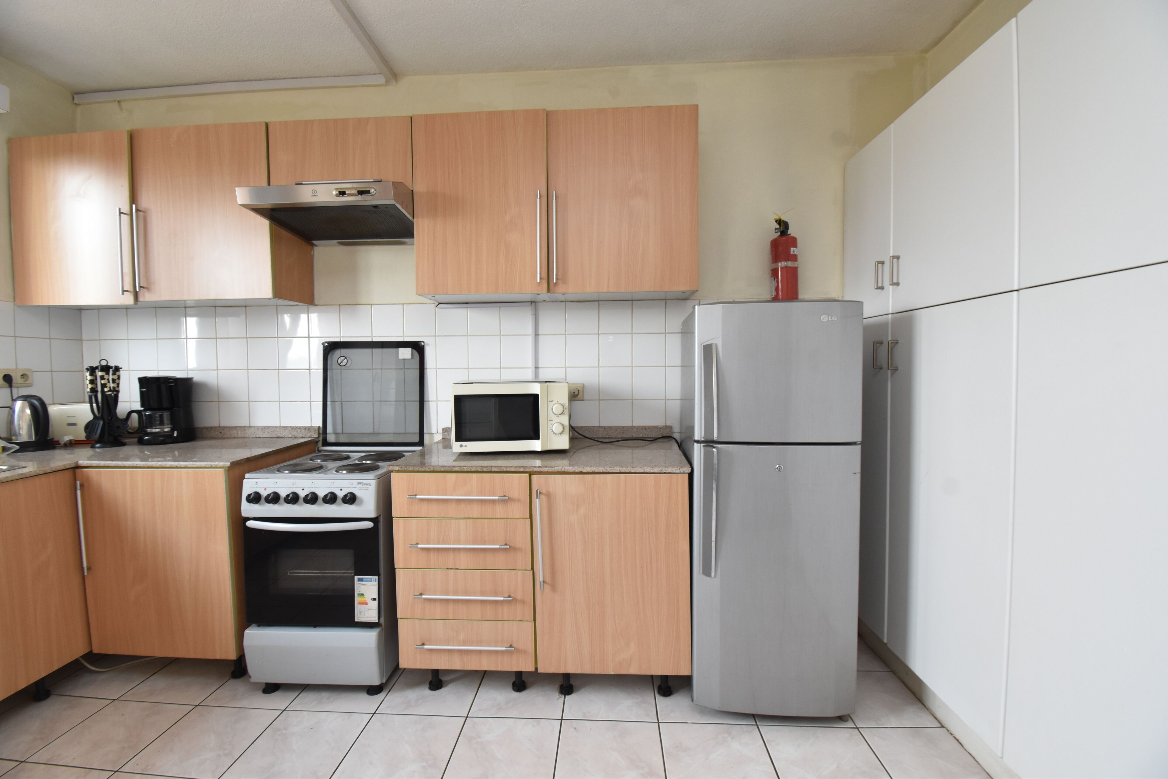 Full-size fridge, microwave, stovetop, cookware/dishes/utensils