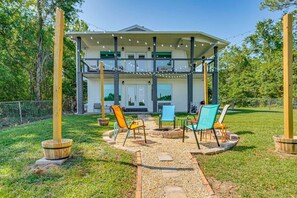 A two-story house with a covered porch, outdoor seating area, and a fire pit. - The Turtles Nest on Mulat Bay in Avalon Beach (Avalon)