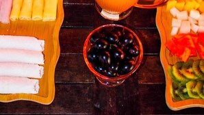 A table set with various breakfast items including pastries, fruits, and beverages. - Pousada Caju Sansete  (Barreirinhas)