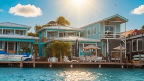 A waterfront property with multiple buildings, a dock with boats, and a pool area. - Double Waterfront Bungalows (#1 & #4) (Bocas del Toro)