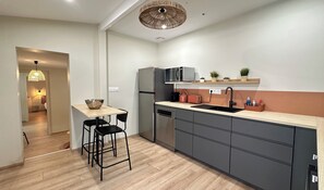 A modern kitchen with a central island, black chairs, a built-in dishwasher, and a microwave above the counter. - House for 8 with garden & terrace in Arcachon (Arcachon)