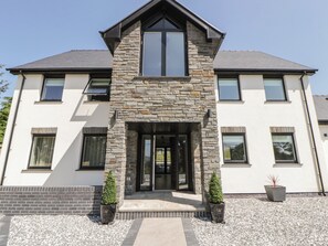A two-story house with a stone facade, large windows, and a front entrance. - Brynseion Uchaf (Aberystwyth)