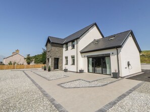 A modern two-story house with a stone facade, large windows, and a gravel driveway. - Brynseion Uchaf (Aberystwyth)