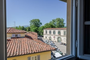 A view of a street with parked cars and buildings with red-tiled roofs. - Elegant And Refined 2-Bedrooms Apartment In The Heart Of Lucca (Lucca)