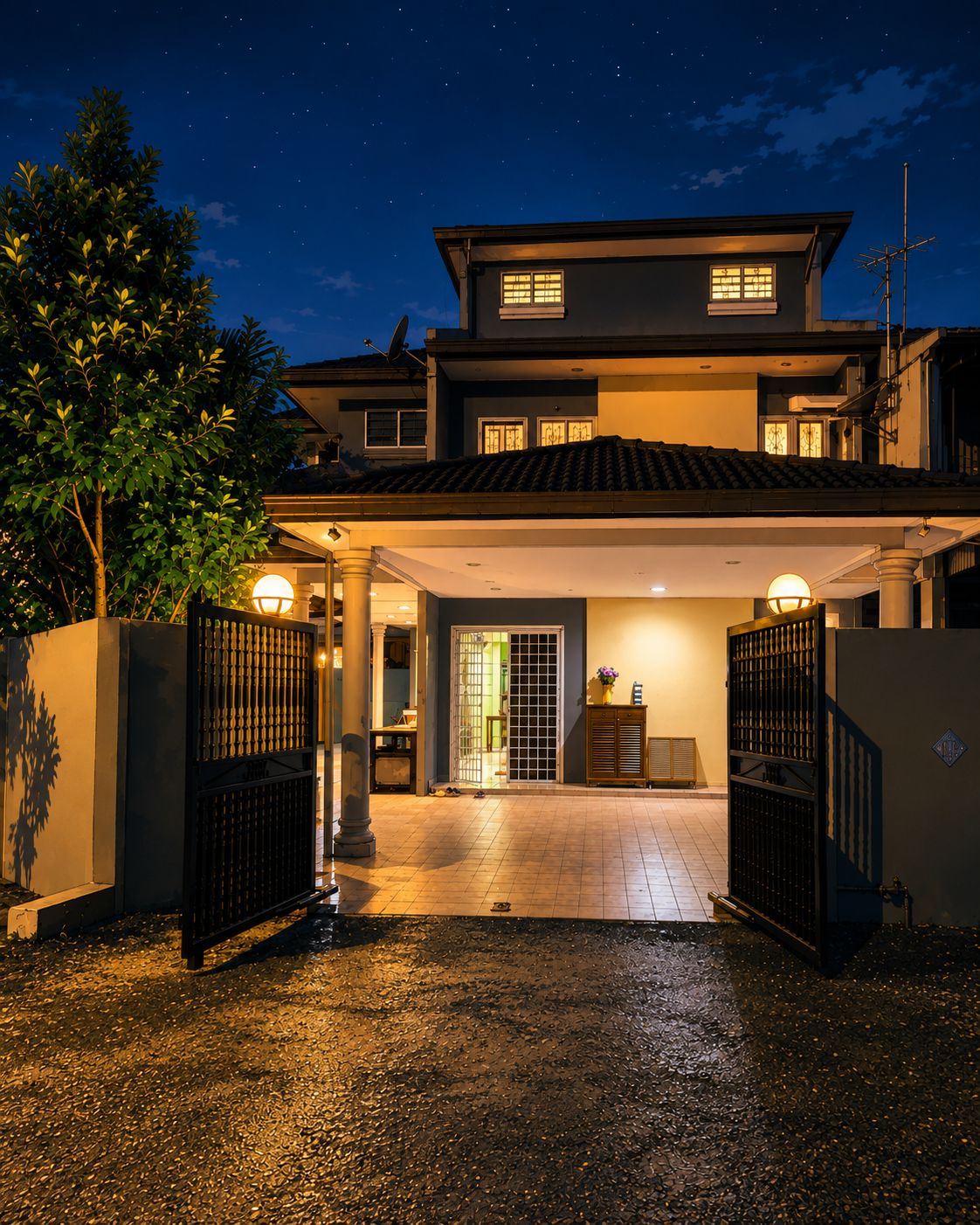 A two-story house with a covered driveway and gated entrance.