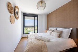 A bedroom with a large bed, a view through a window, and a ceiling light fixture. - Allonbay Aster 6 - Sea View & Private Jacuzzi (Villajoyosa)