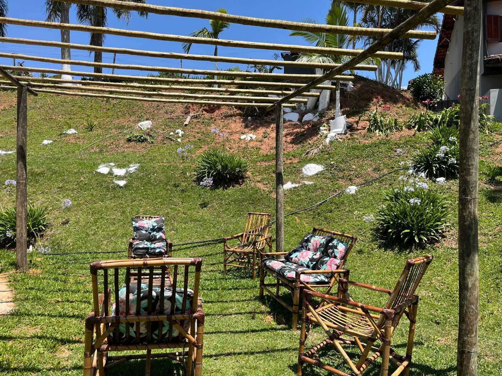 A covered outdoor seating area with bamboo furniture and a pergola.