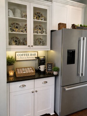 A kitchen with white cabinetry, a coffee bar area, a stainless steel refrigerator, and decorative items. - Riverwood Masters Rental 2+ miles to  Champions Retreat Golf Course Evans GA (Evans)