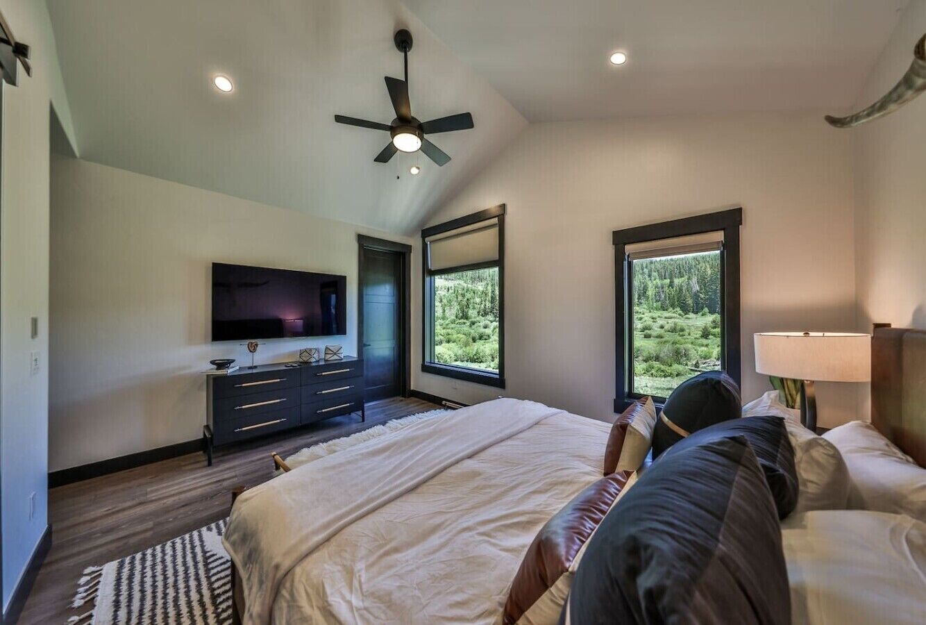 Master bedroom 1 with king bed, smart tv, and ensuite