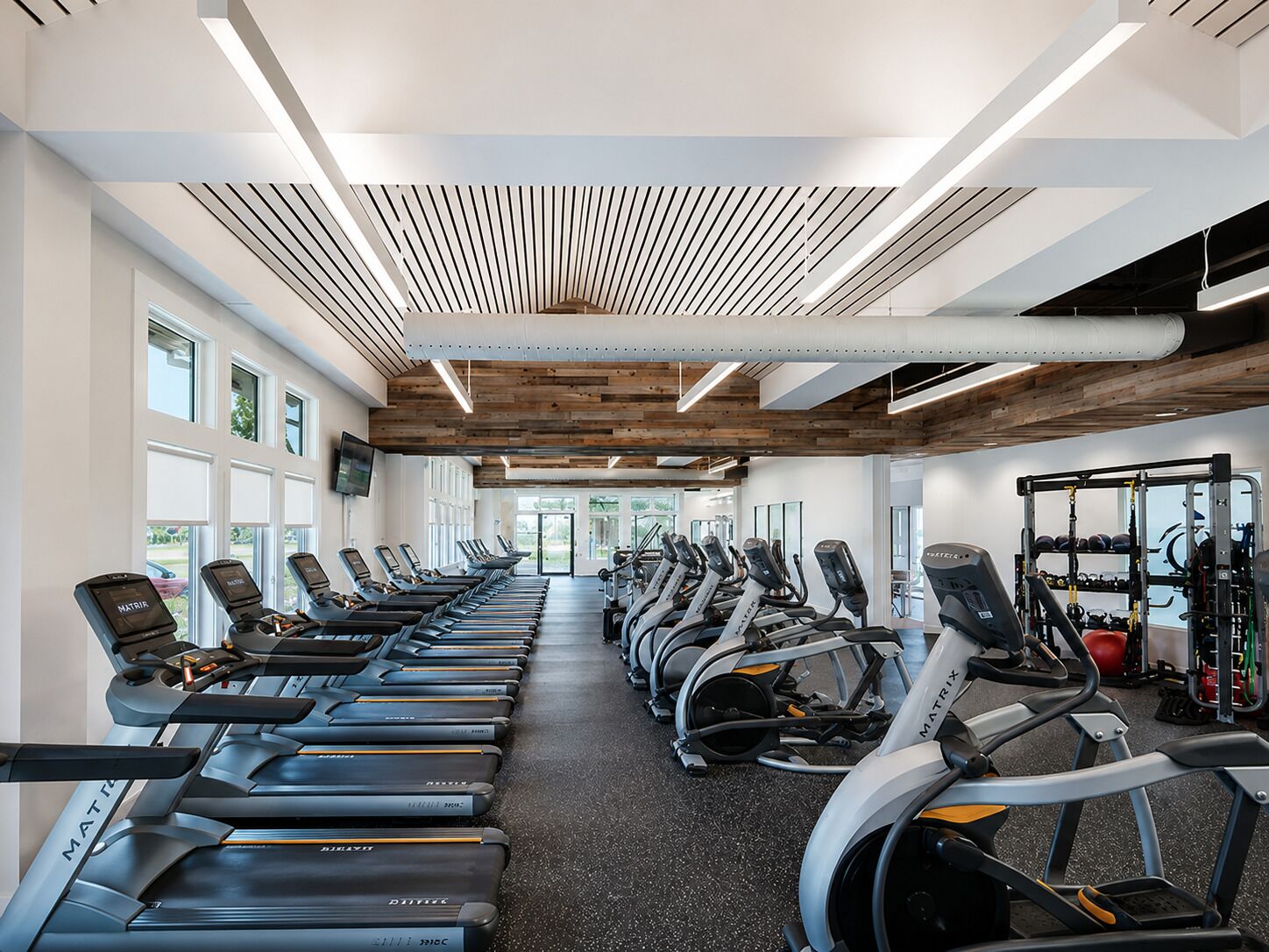 A gym with treadmills, ellipticals, and weight machines.
