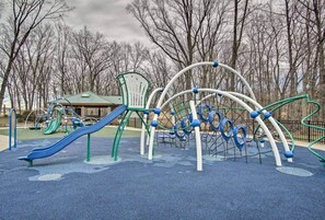 Une aire de jeux avec des toboggans, des structures d’escalade et un espace de repos abrité.