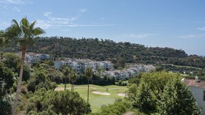 A golf course with a residential area in the background.