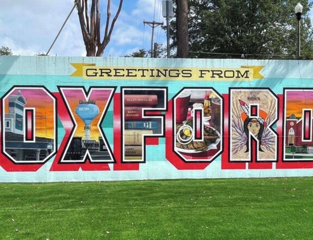 A colorful mural with the word 'OXFORD' and various images of local attractions.