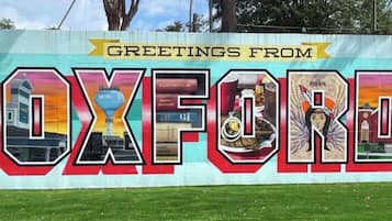 A colorful mural with the word 'OXFORD' and various images of local attractions.