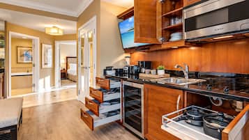 A modern kitchen with wooden cabinets, a Bosch microwave, and a built-in oven.