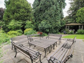 A garden with a gazebo, benches, and a variety of trees. - Kwerky Cottage (Lydbury North)