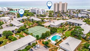 A residential area with a tennis court, a swimming pool, and a view of the ocean. - My Blue Heaven 30A Getaway - Beach Access, Pools & Prime 30A Location (Santa Rosa Beach)